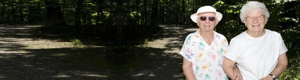 Image of two women walking a trail